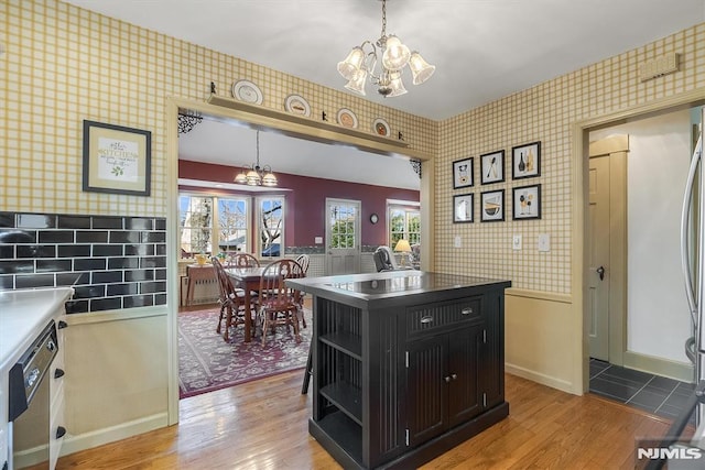 kitchen featuring a center island, an inviting chandelier, light hardwood / wood-style flooring, and hanging light fixtures