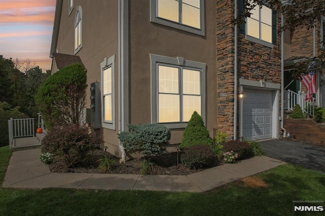 property exterior at dusk with a garage