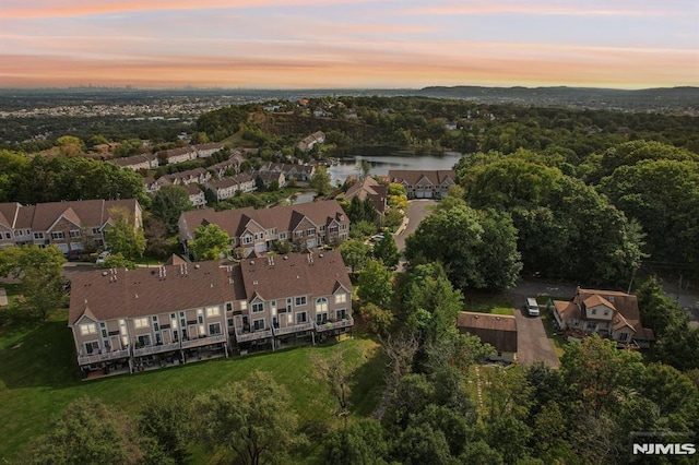 aerial view at dusk with a water view