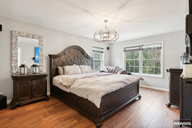 bedroom featuring a chandelier and wood-type flooring