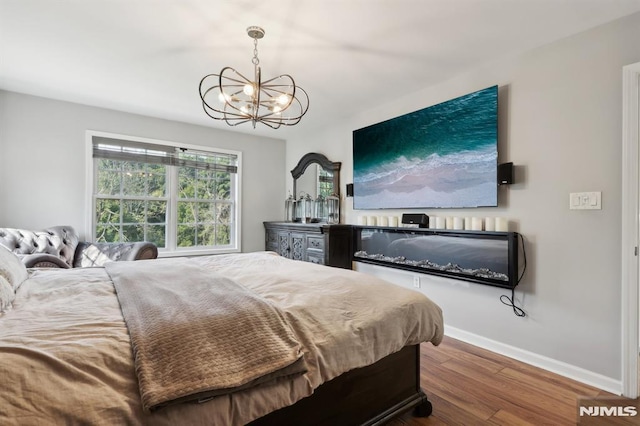 bedroom with a chandelier and wood-type flooring