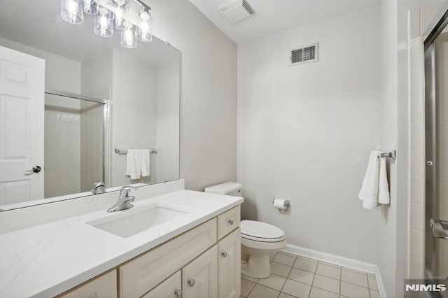 bathroom with tile patterned flooring, an enclosed shower, vanity, and toilet