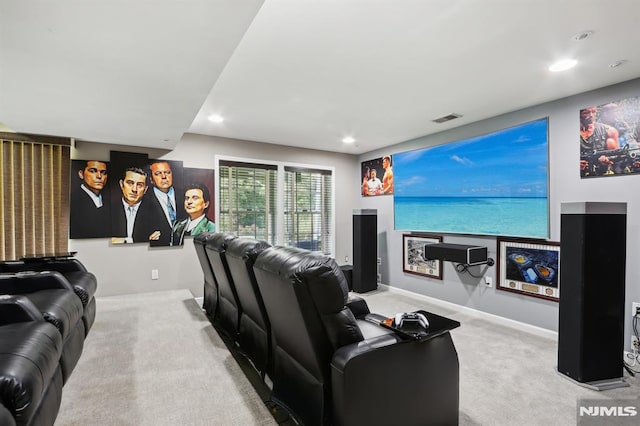 home theater room with light colored carpet