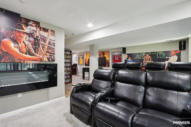 cinema room featuring light carpet