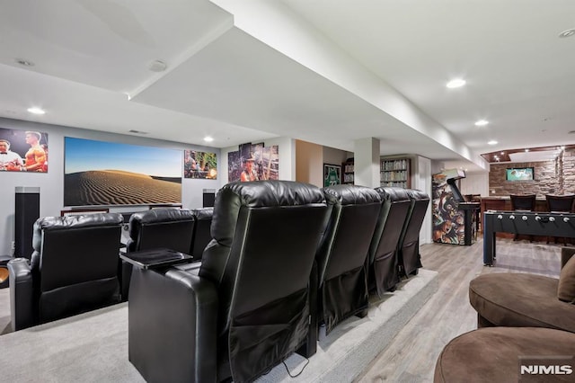 cinema room with light hardwood / wood-style floors