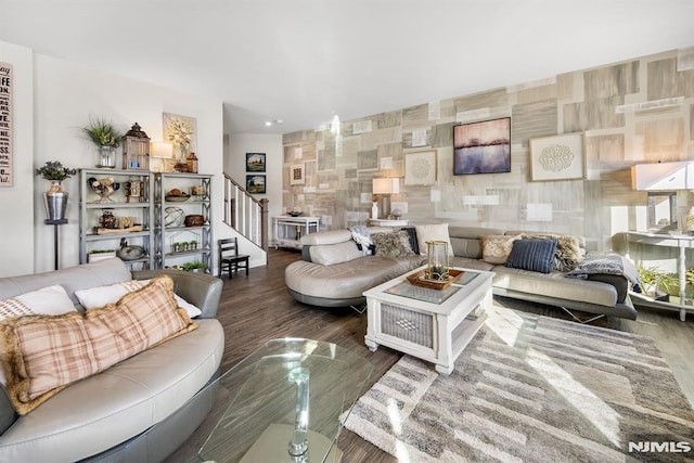 living room featuring dark hardwood / wood-style flooring and tile walls