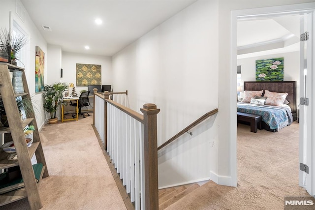 hallway with light colored carpet