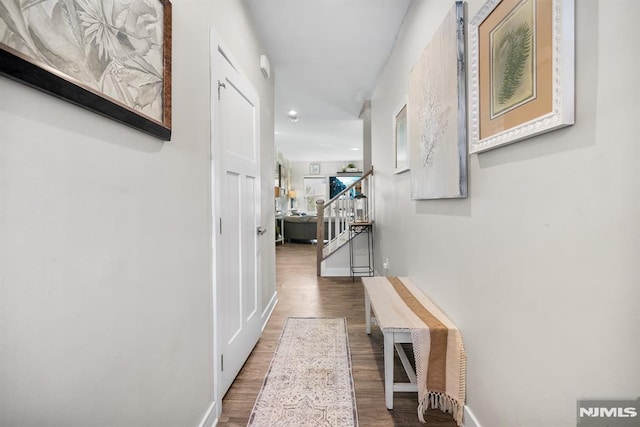 hallway with hardwood / wood-style flooring