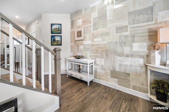 stairway featuring hardwood / wood-style floors and tile walls