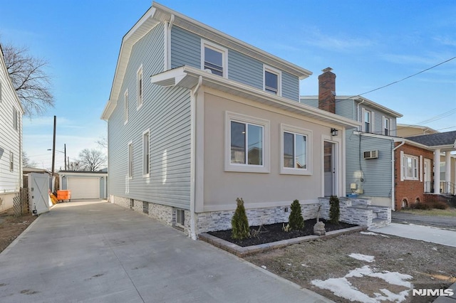 view of front of home with a garage and an outdoor structure