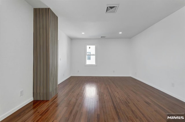 spare room featuring dark hardwood / wood-style flooring