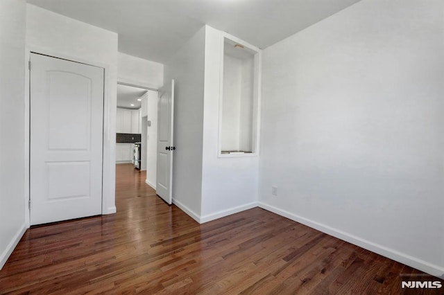 empty room with dark hardwood / wood-style floors