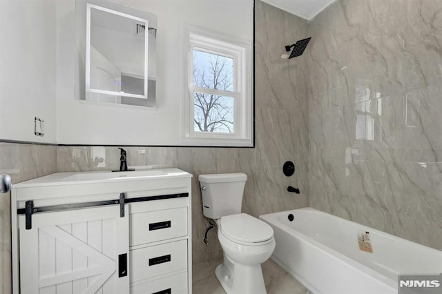 full bathroom with toilet, vanity, and tiled shower / bath