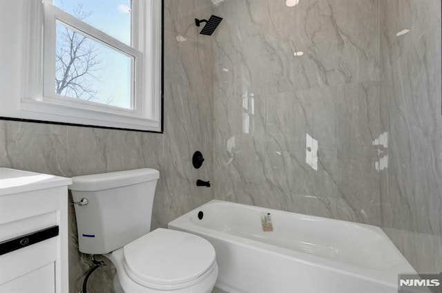 full bathroom with toilet, vanity, and shower / washtub combination