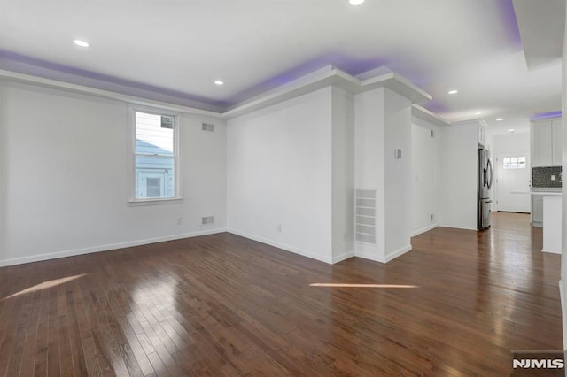 unfurnished living room featuring dark wood-type flooring