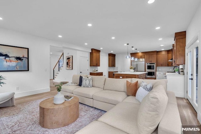 living room featuring light hardwood / wood-style floors and sink