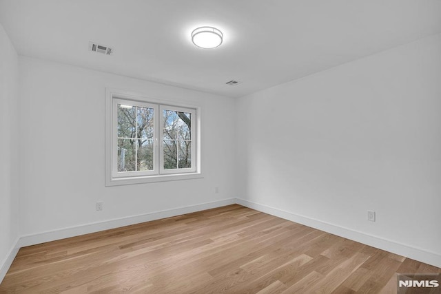 spare room featuring light hardwood / wood-style flooring