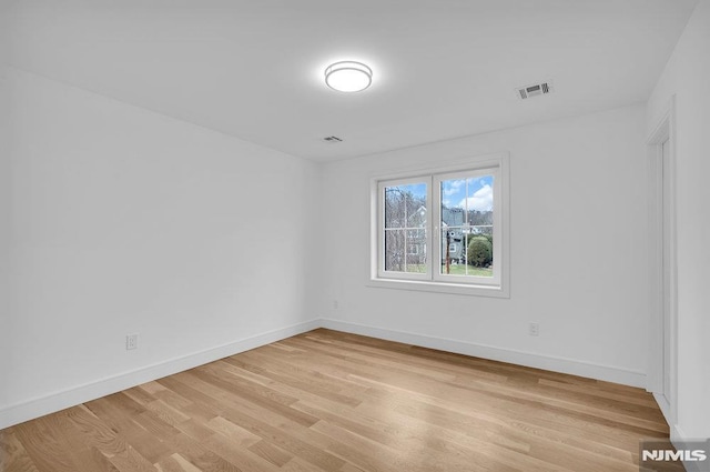 empty room with light hardwood / wood-style floors