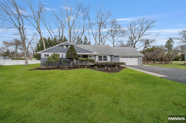 ranch-style house featuring a front yard and a garage