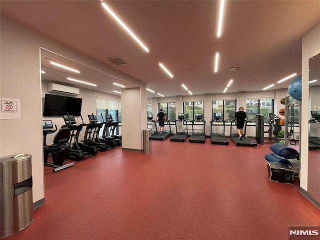 workout area with a wall mounted air conditioner