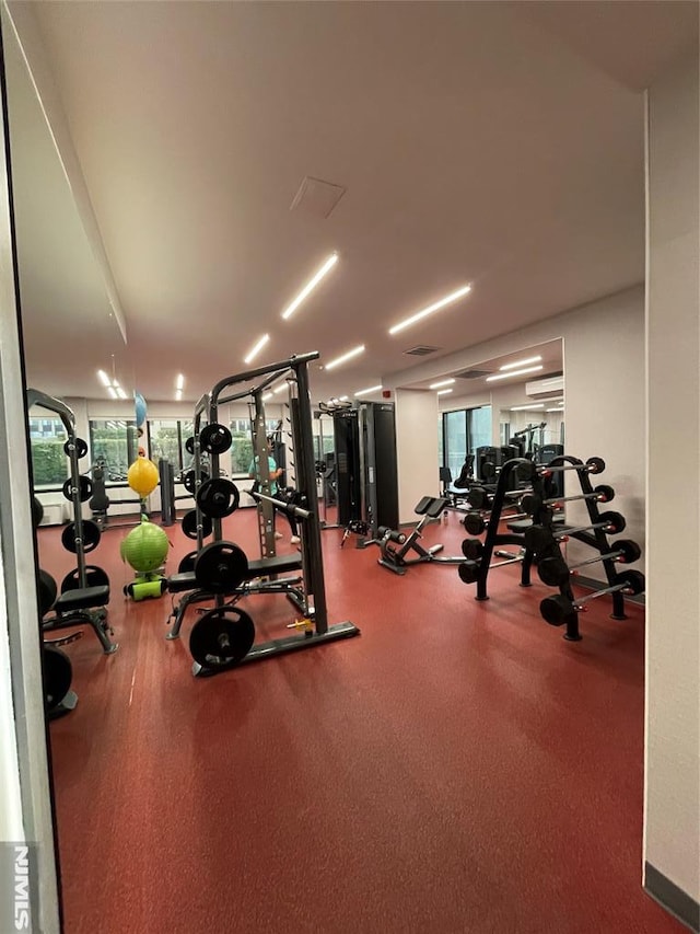 workout area featuring an AC wall unit