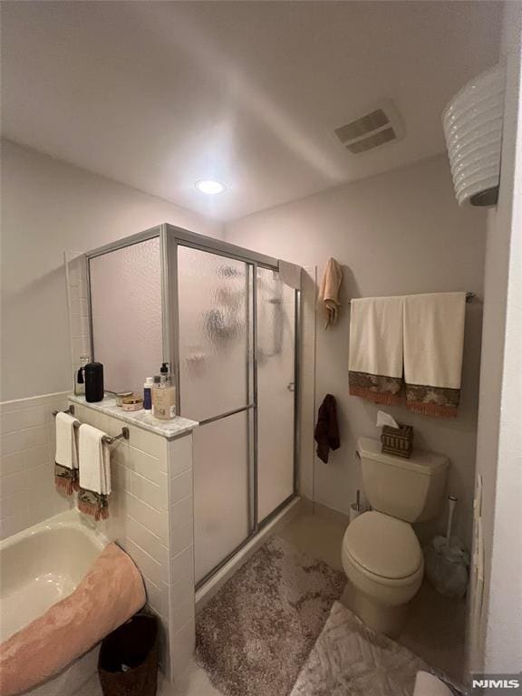 bathroom with toilet and a shower with door