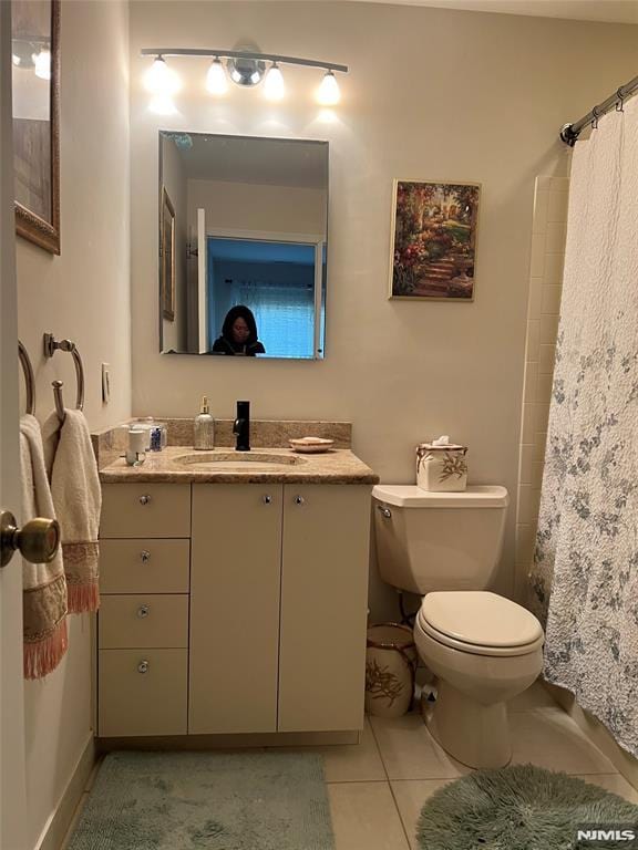 bathroom with vanity, tile patterned floors, and toilet