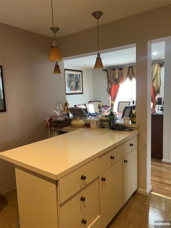 kitchen with hanging light fixtures and light tile patterned flooring