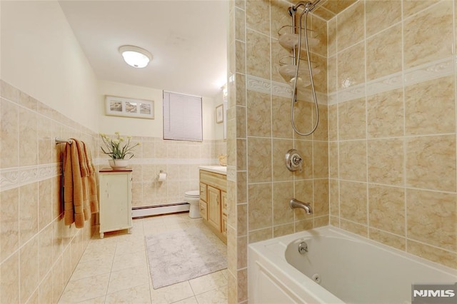 full bathroom with vanity, tile patterned floors, tiled shower / bath combo, tile walls, and a baseboard radiator