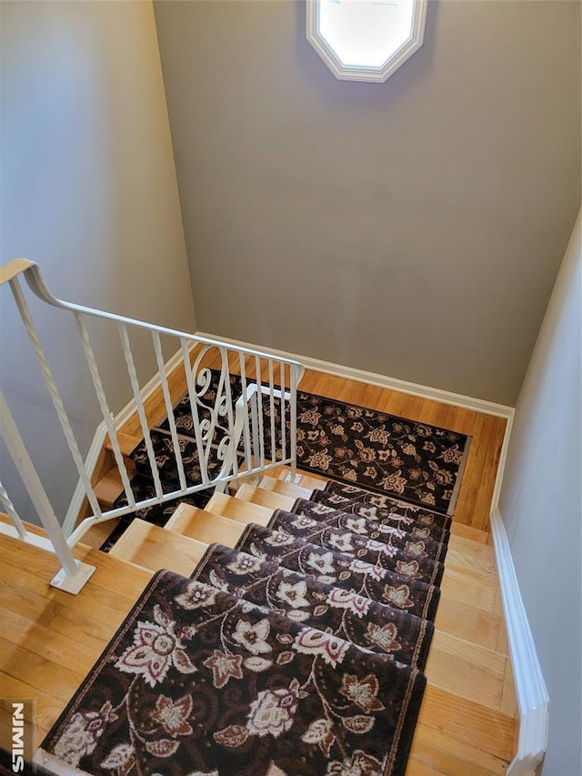 stairway with hardwood / wood-style flooring