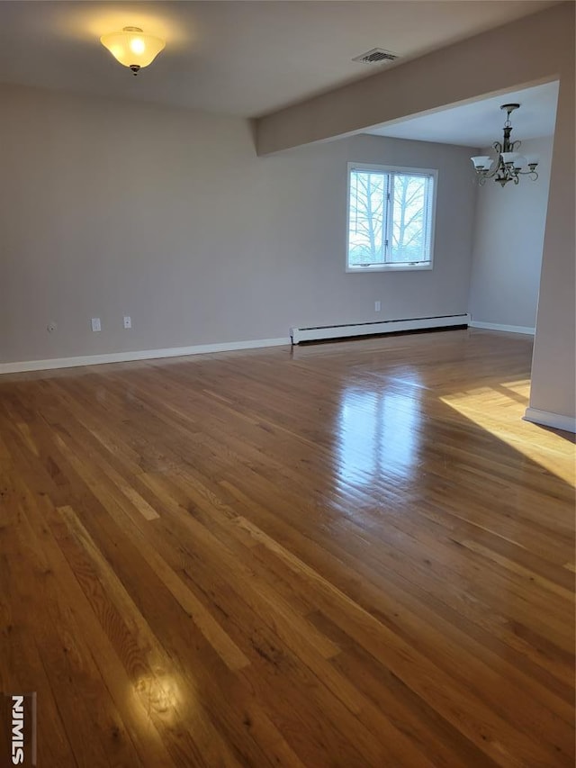 unfurnished room featuring hardwood / wood-style floors, beamed ceiling, a baseboard radiator, and a notable chandelier