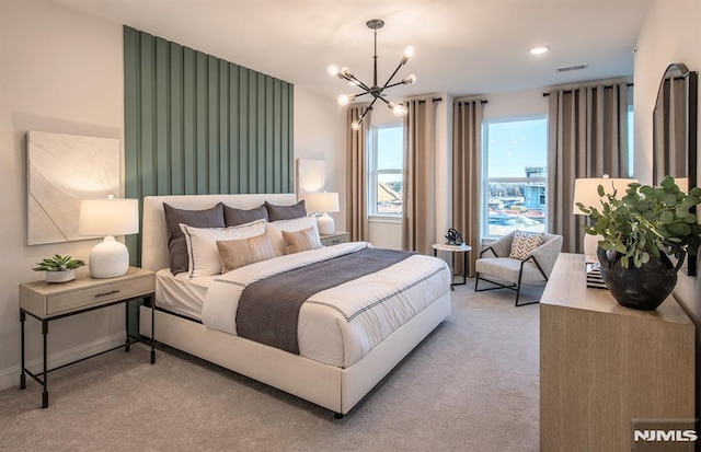 carpeted bedroom with a chandelier