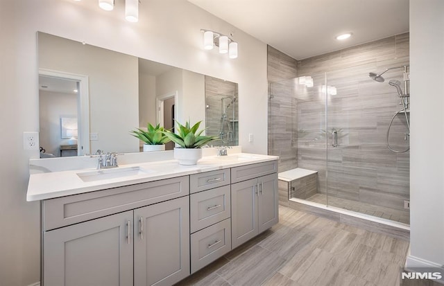 bathroom with vanity and a shower with shower door