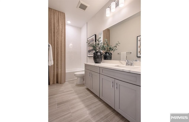 full bathroom with shower / bath combo, toilet, and vanity