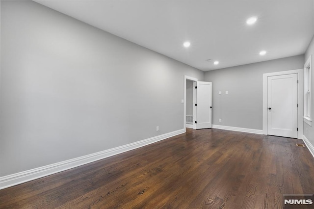 unfurnished room featuring dark hardwood / wood-style flooring