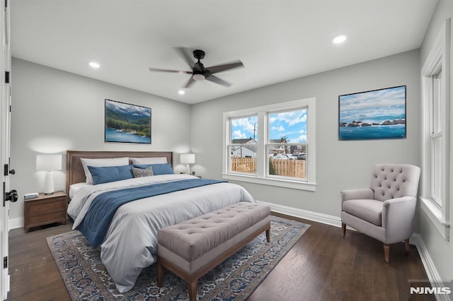 bedroom with dark hardwood / wood-style flooring and ceiling fan