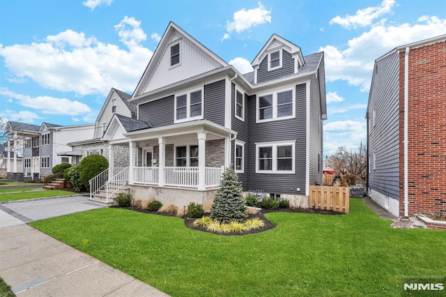 view of front of home with a front lawn and covered porch