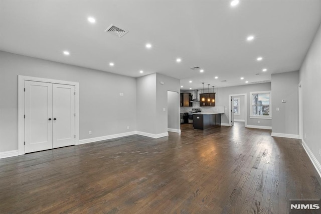 unfurnished living room featuring dark hardwood / wood-style floors