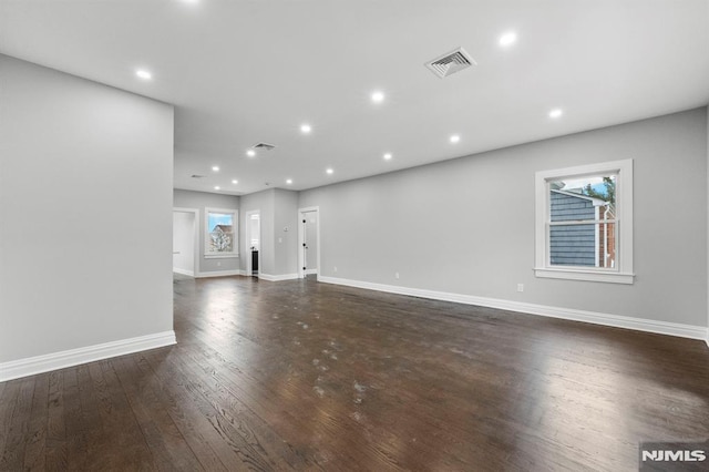 unfurnished living room featuring dark hardwood / wood-style floors