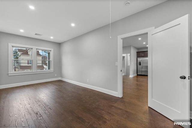 spare room featuring dark hardwood / wood-style floors