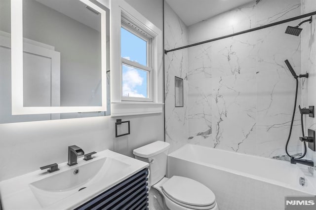 full bathroom with vanity, toilet, and tiled shower / bath