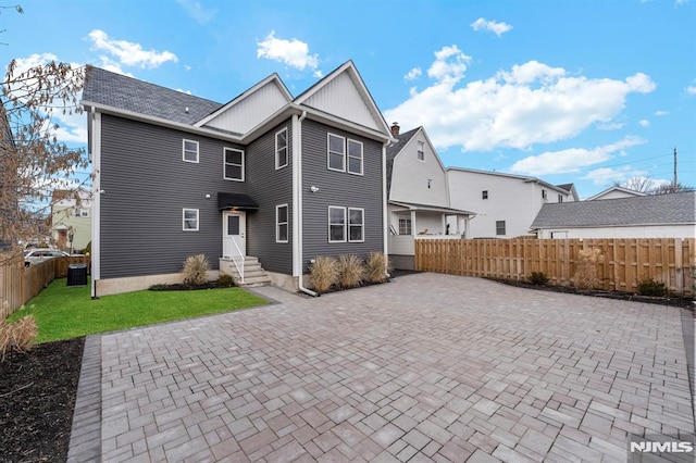 rear view of property featuring a lawn