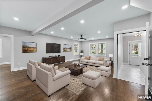 living room with hardwood / wood-style flooring, plenty of natural light, beam ceiling, and ceiling fan with notable chandelier