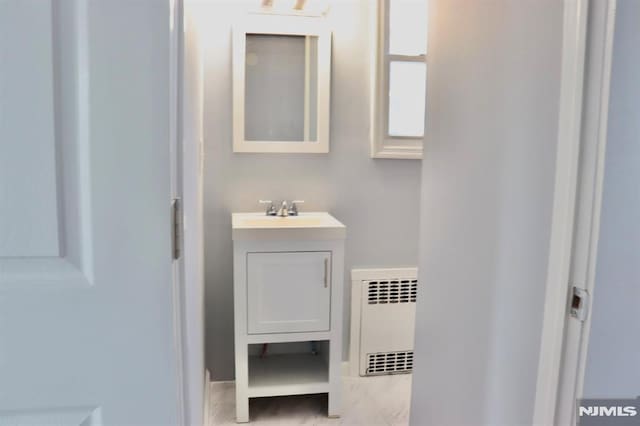 bathroom with vanity and radiator