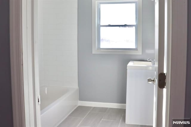 bathroom with tile patterned floors and vanity