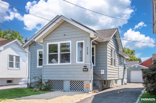 bungalow-style home with an outbuilding and a garage