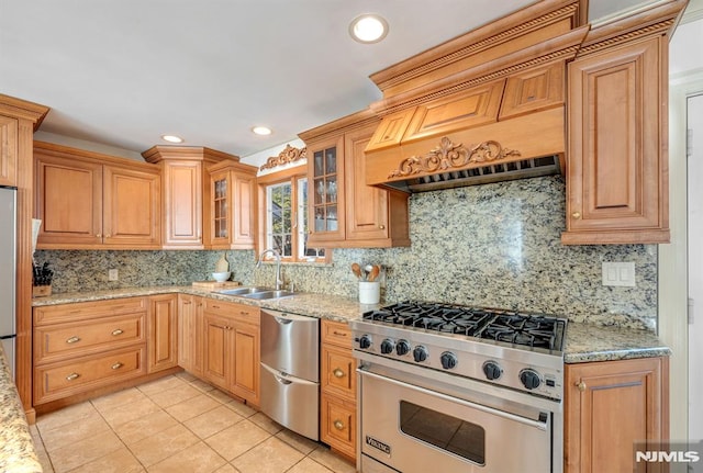 kitchen with stainless steel appliances, light stone counters, and decorative backsplash