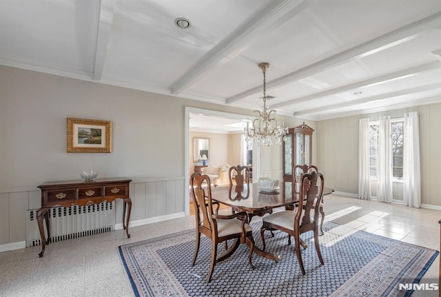 dining room with beam ceiling, a notable chandelier, and radiator