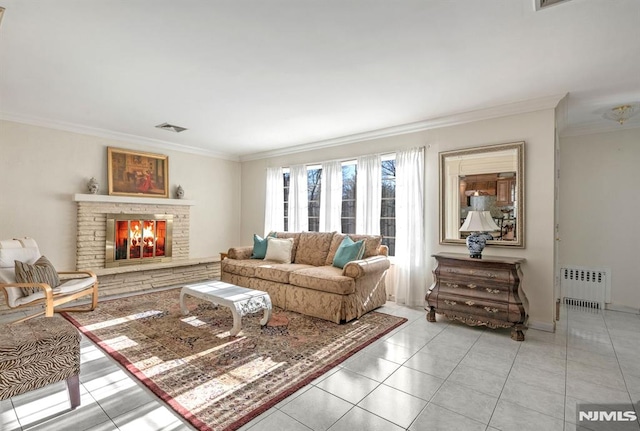 living room featuring ornamental molding, a stone fireplace, radiator heating unit, and light tile patterned flooring