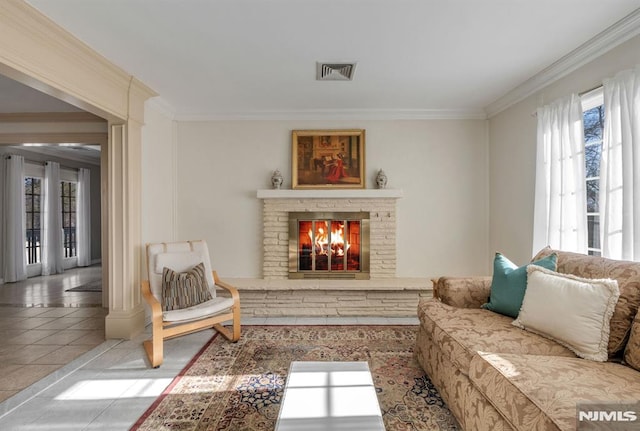 tiled living room with crown molding and a fireplace